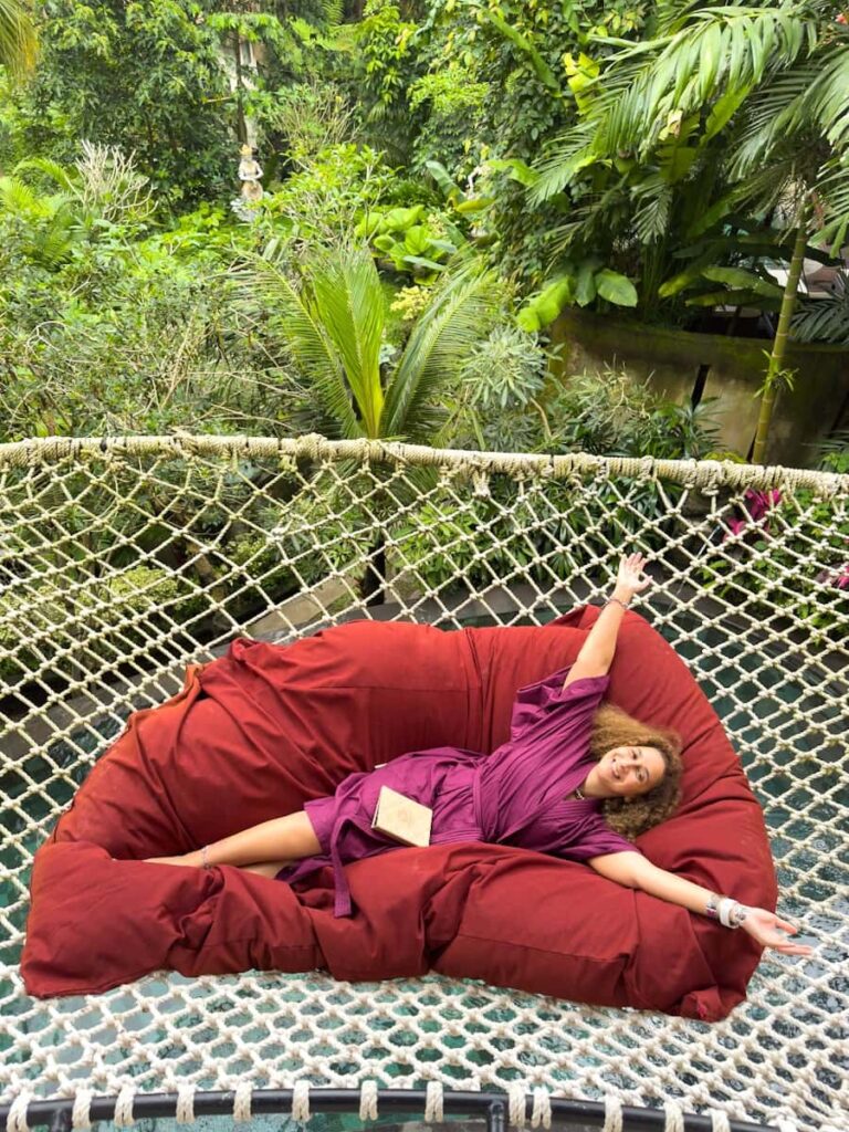 Sally is reading a book on the hammock located in second floor of our private pool villa in the Udaya Ubud Hotel Bali