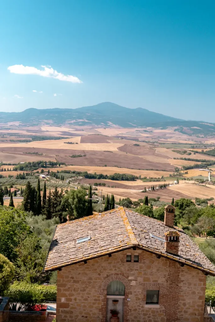 Florence 3 Days Itinerary: A Perfect Guide For First Timers A scenic countryside landscape and a beautiful house in Pienza tuscany Italy featuring rolling hills, greenery, and distant buildings