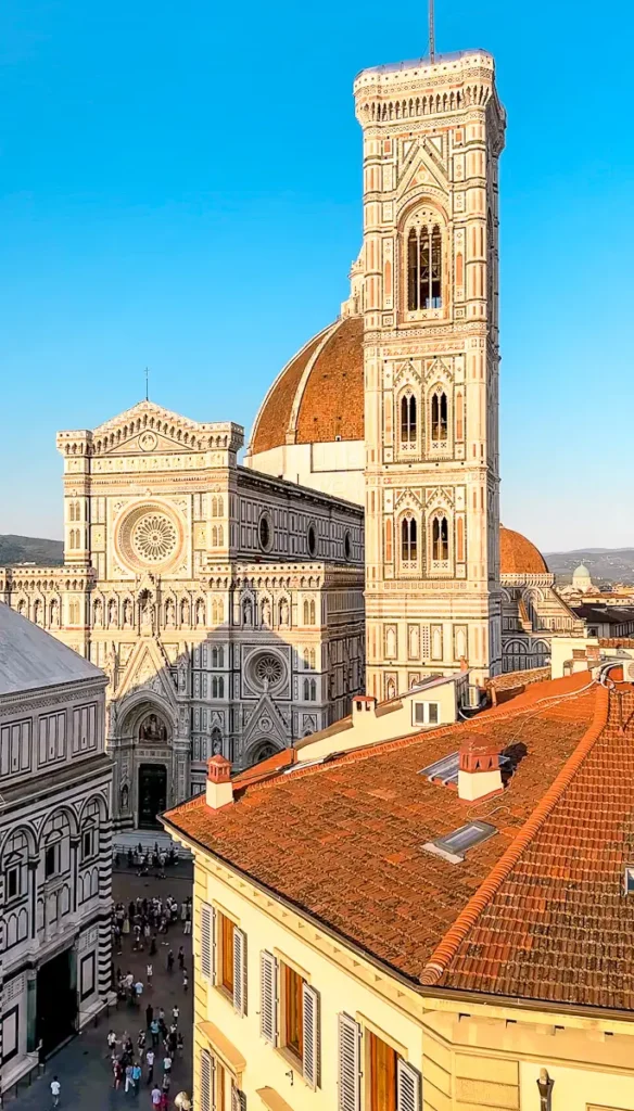 View of Giotto’s Campanile in Florence Italy under a clear blue sky with surrounding historic architecture. The composition highlights the beauty near the B&B La terraza sul Duomo in florence italy accommodation.