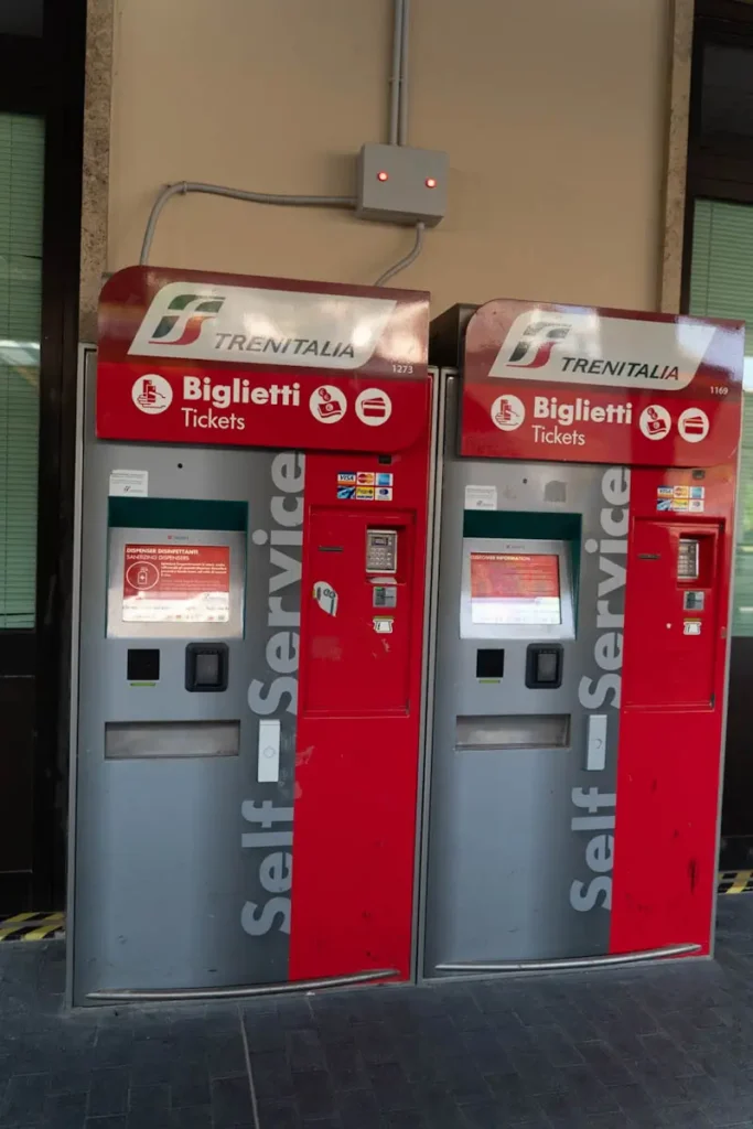 Best Cinque Terre Tour From Florence: Review & My Experience Red train ticket machine in Italy