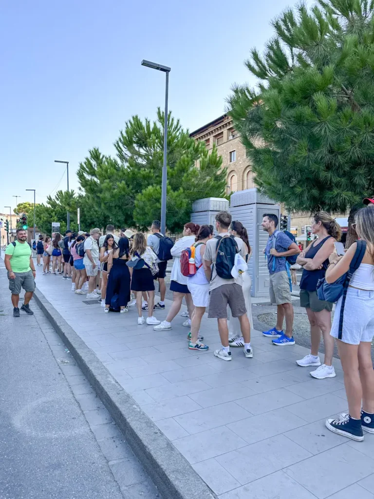 Best Cinque Terre Tour From Florence: Review & My Experience tourists waiting to board bus on there day trip in italy